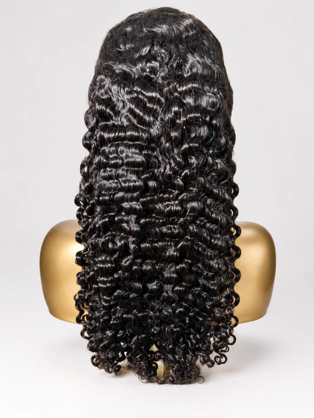 Dark Burmese-curly wig on a clean cream background