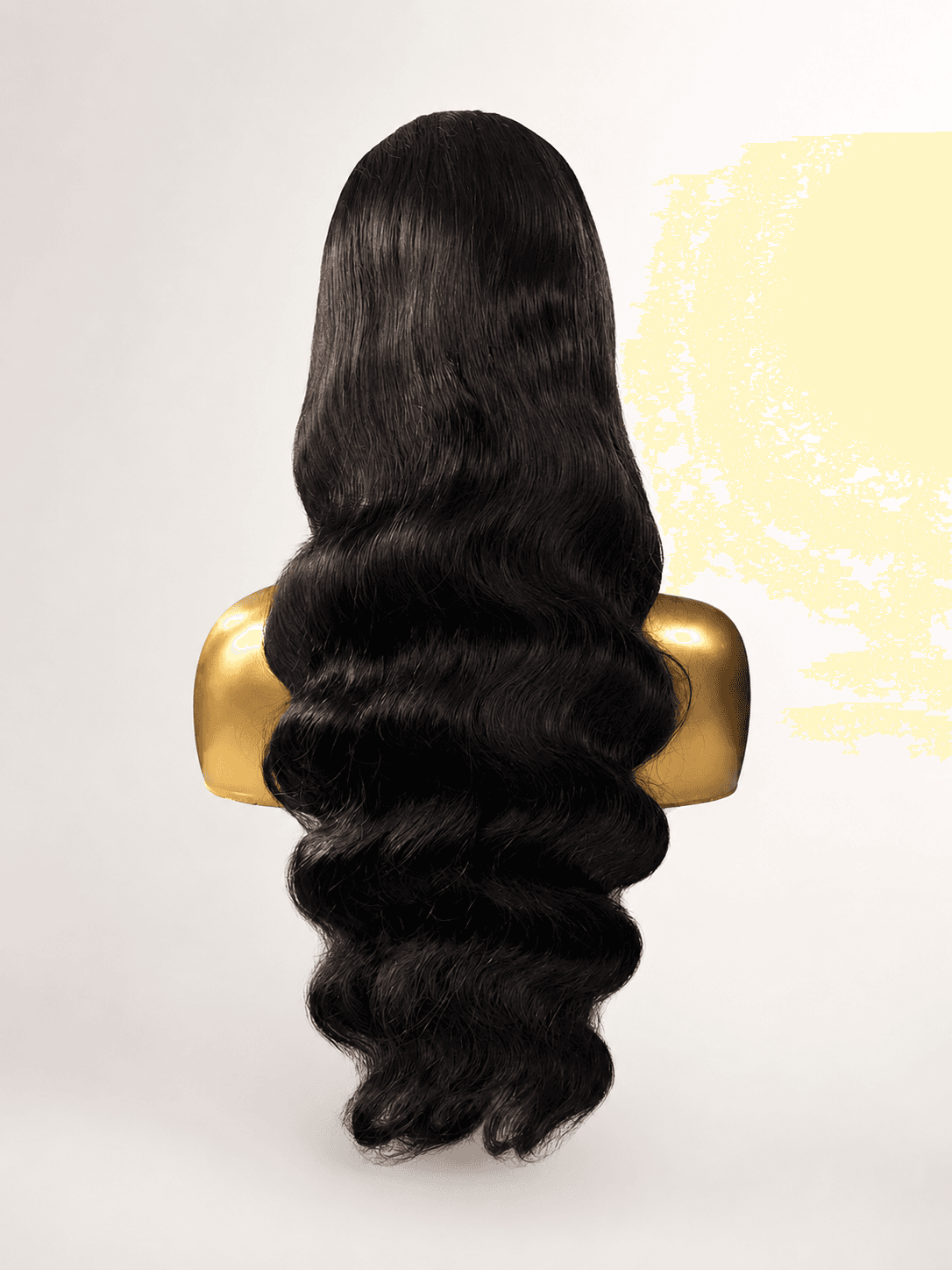 Full dark body-wave wig on a clean cream background