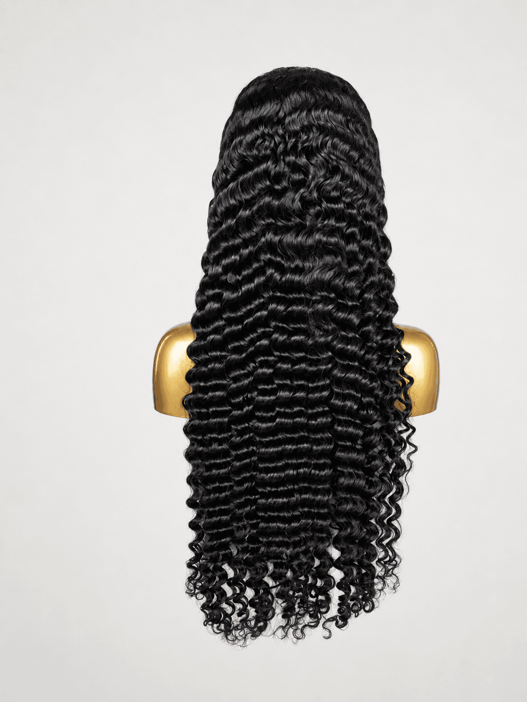 Full dark deep-wave wig on a clean cream background